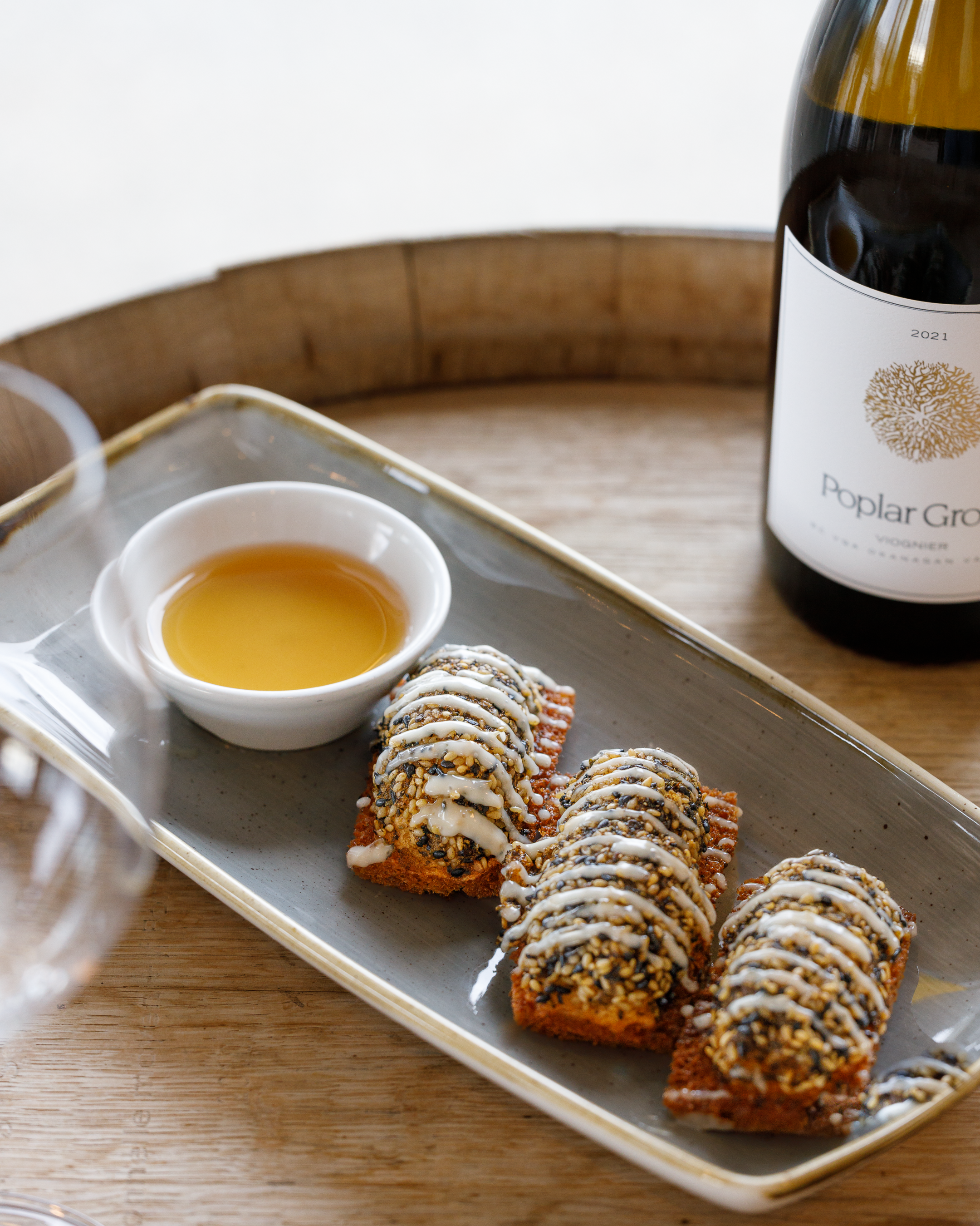 a plate of prawn toast and bottle of wine at the Restaurant at Poplar Grove