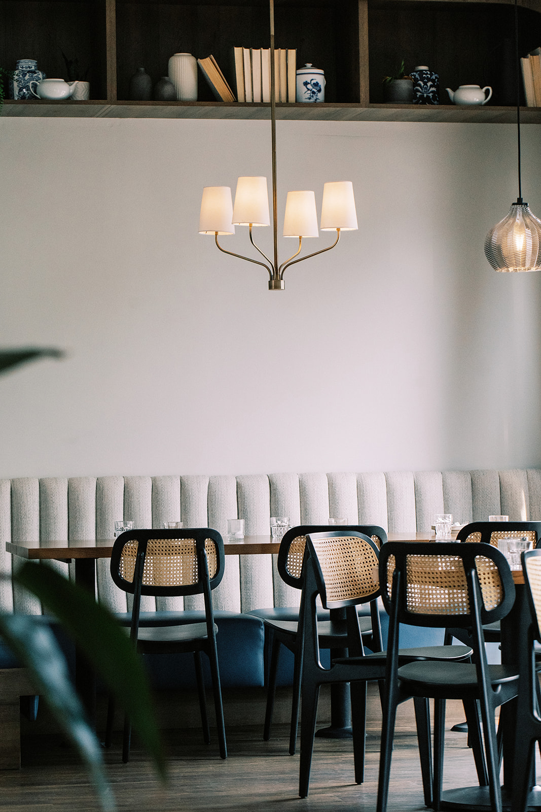 Kin + Folk bench seating with additional chairs and empty tables showcasing the beautiful modern space